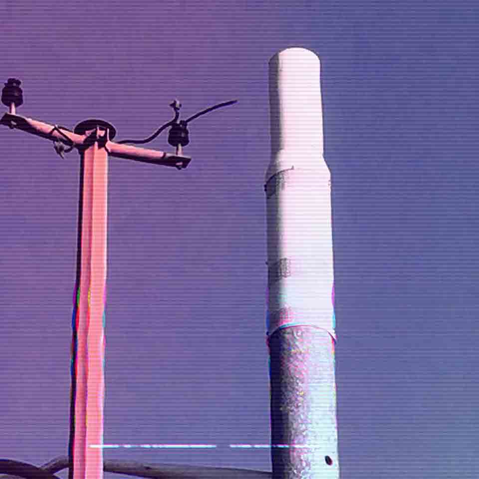A 5G antenna next to a retired telephone pole.